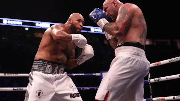 Frazer Clarke (left) in action against Kamil Sokolowski in the heavy-weight bout at the AO Arena, Manchester in November 12, 2022. The Polish professional boxer Sokolowski has been banned from all sport for a period of three years following Anti-Doping Rule Violations. IAN HODGSON/PA IMAGES VIA GETTY IMAGES.
